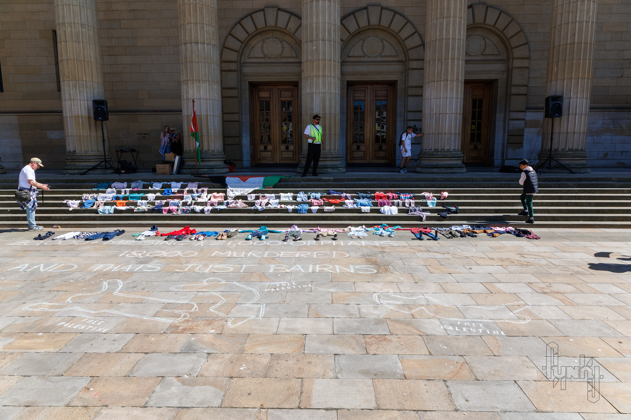 Chalk Drawings Representing Dead Bodies, with the Numbers of Murdered Children and Clothing Placed for Symbolism.